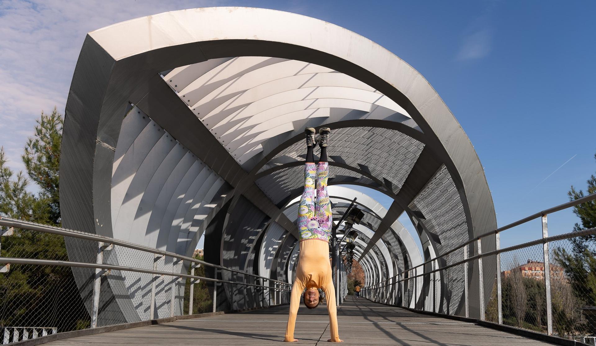 Coach Irela performing a handstand, showcasing strength and core